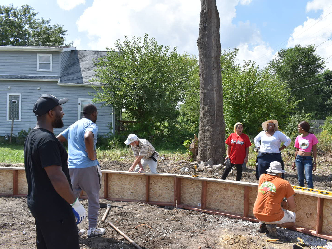 Volunteers cutting and building raised bed frames at the E. Vernor site